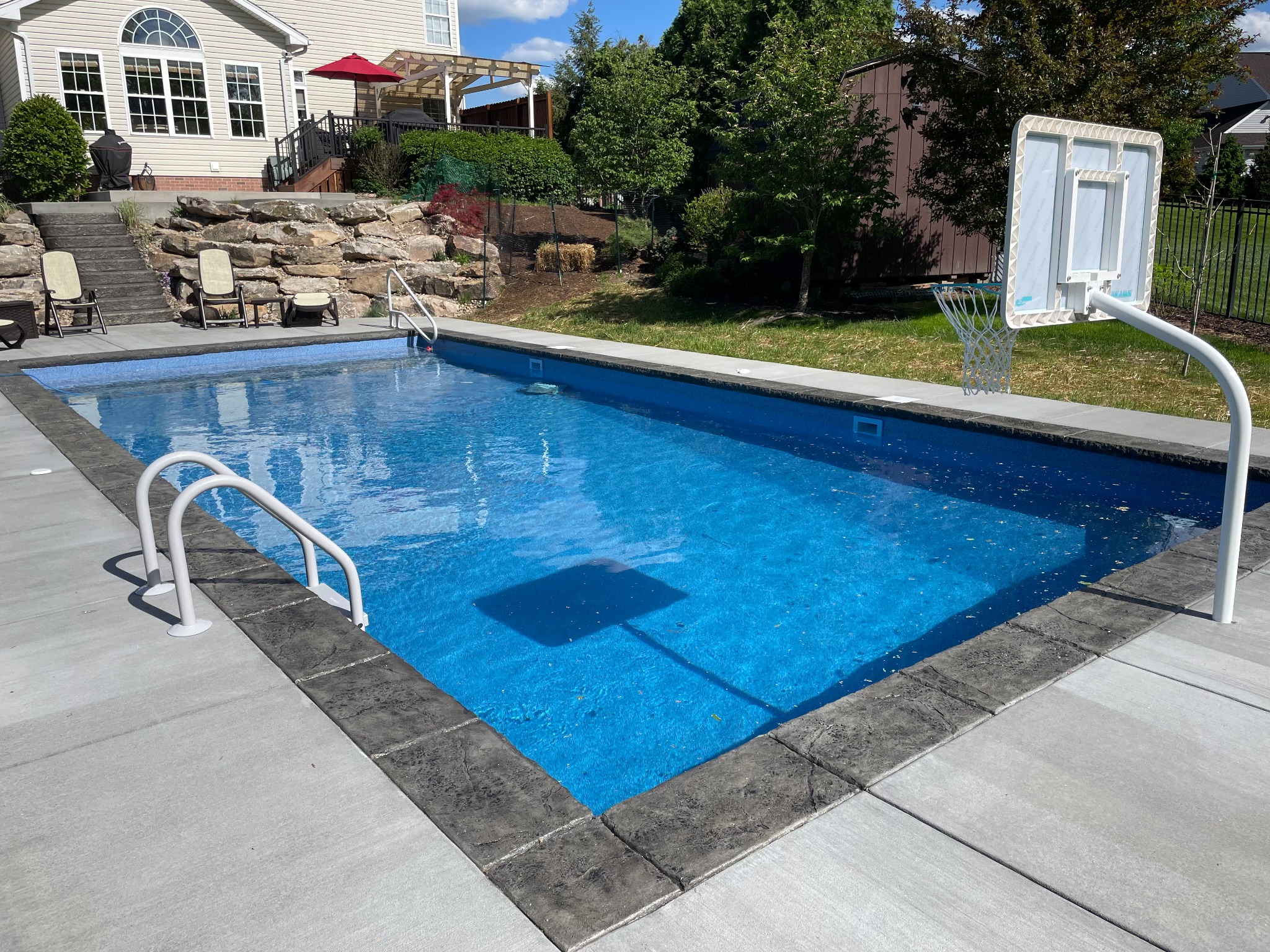 Rectangular pool with basketball hoop